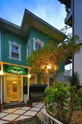 a green building with a sign in front of it at Hotel Historia-Special Category in Istanbul