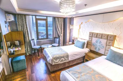 a hotel room with two beds and a large window at Grand Star Hotel Bosphorus & Spa in Istanbul