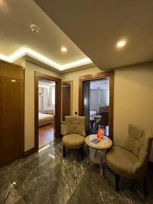 a lobby with two chairs and a table and a room at Grand Star Hotel Bosphorus & Spa in Istanbul