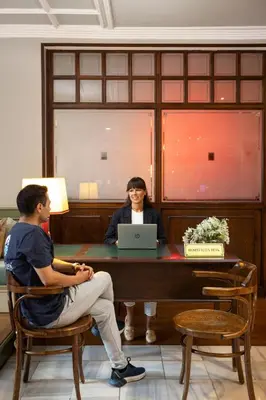 a man and a woman sitting at a desk with a laptop at Armada Istanbul Old City Hotel in Istanbul