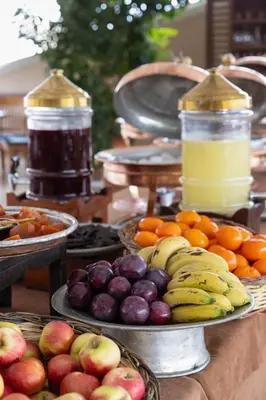 a table topped with bowls of fruit on plates at Armada Istanbul Old City Hotel in Istanbul