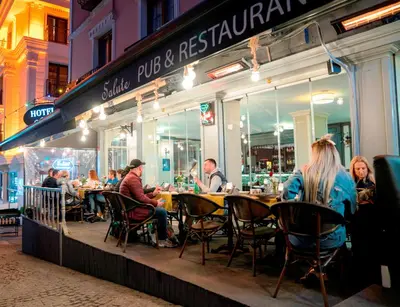 a group of people sitting at tables outside a restaurant at Hotel Agan Oldcity Istanbul in Istanbul