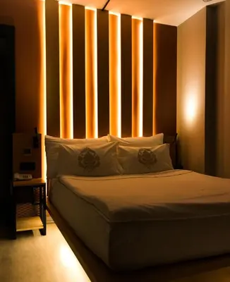 a bedroom with a bed with a wall with vertical stripes at Antik Hotel Istanbul in Istanbul