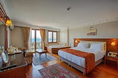 a hotel room with a bed and a bath tub at Hotel Sumengen in Istanbul