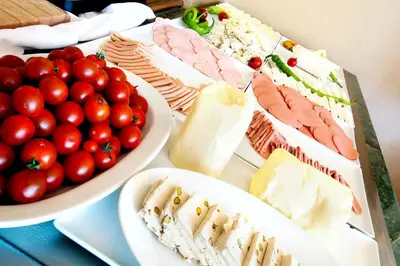 a table topped with plates of food and bowls of tomatoes at Hotel Sumengen in Istanbul