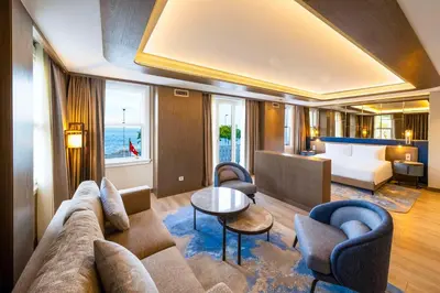 a living room with a couch and chairs and a bed at Radisson Hotel Istanbul Sultanahmet in Istanbul