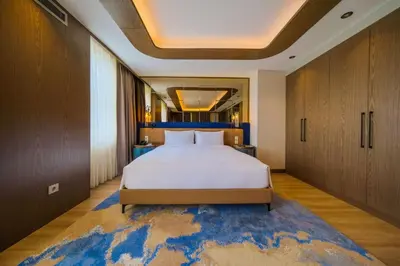 a bedroom with a large bed and a blue rug at Radisson Hotel Istanbul Sultanahmet in Istanbul