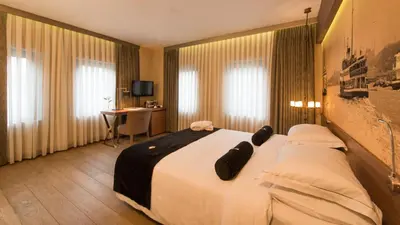 a hotel room with a large bed and a desk at Hotel Saint Sophia in Istanbul