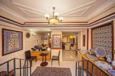 a living room with a ceiling with a chandelier at Hippodrome Hotel in Istanbul