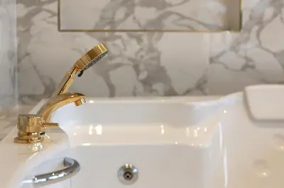 a bathroom sink with a faucet and a bath tub at Mina Hotel - Special Category in Istanbul