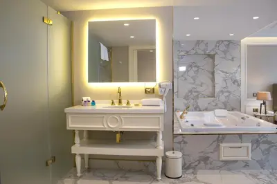 a bathroom with a sink and a mirror and a tub at Mina Hotel - Special Category in Istanbul