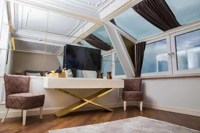 a room with a tv and a desk with two chairs at Mina Hotel - Special Category in Istanbul