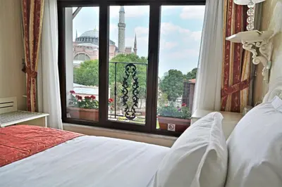 a bedroom with a window with a view of a mosque at The And Hotel Sultanahmet - Special Category in Istanbul