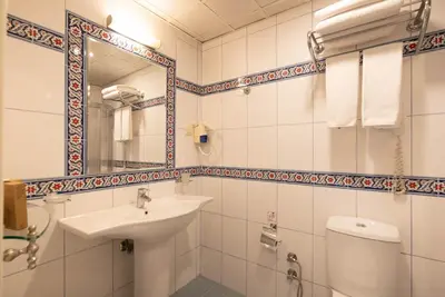 a bathroom with a sink and a toilet and a mirror at The And Hotel Sultanahmet - Special Category in Istanbul