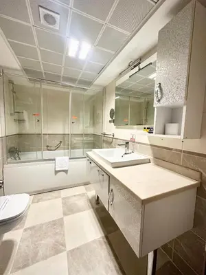 a bathroom with a sink and a shower and a toilet at Askoc Hotel & SPA in Istanbul