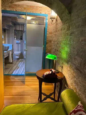 a room with a table and a green lamp at Hotel Niles Istanbul in Istanbul