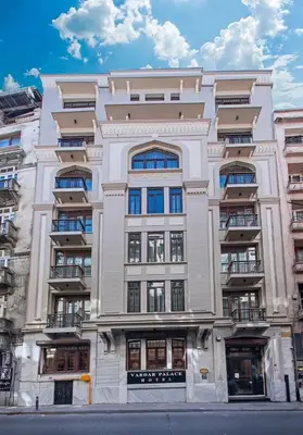 a tall white building with many windows on a street at Vardar Palace Hotel - Special Category in Istanbul