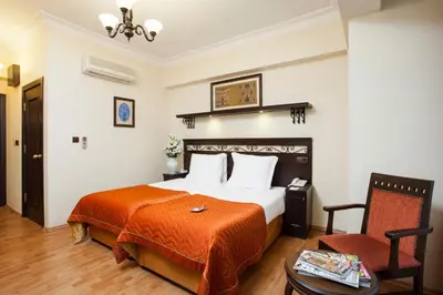 a hotel room with a bed and a chair at Ottoman Hotel Imperial-Special Category in Istanbul