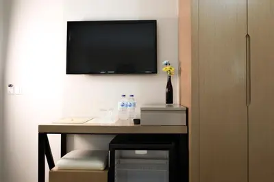a room with a desk with a television on a wall at Sude Konak in Istanbul