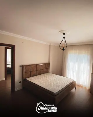 a bedroom with a bed and a chandelier at Ihlamurlu Home in Sapanca