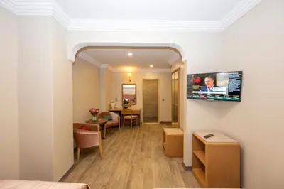 a hotel room with a tv on a wall at Grand Anka Hotel in Istanbul