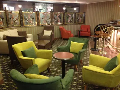 a waiting room with colorful chairs and tables at Grand Anka Hotel in Istanbul