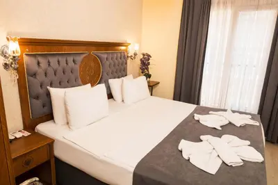 a hotel room with a bed with two towels on it at A'la Sofia Hotel İstanbul in Istanbul