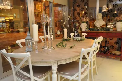 a dining room table with candles and white chairs at Taksim Gonen Hotel in Istanbul