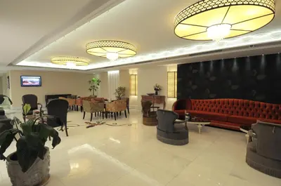 a lobby with a red couch and a dining room at Taksim Gonen Hotel in Istanbul