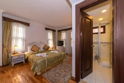 a bedroom with a bed and a door to a bathroom at Arena Hotel - Special Class in Istanbul