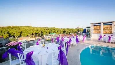a table set up for a wedding next to a pool at Orka Royal Hotel & Spa in Istanbul