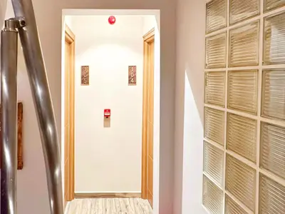 a white door with a mirror in a hallway at Sultan Pier Hotel in Istanbul