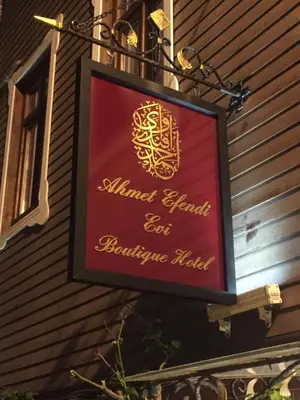 a sign for a restaurant on the side of a building at Ahmet Efendi Evi in Istanbul
