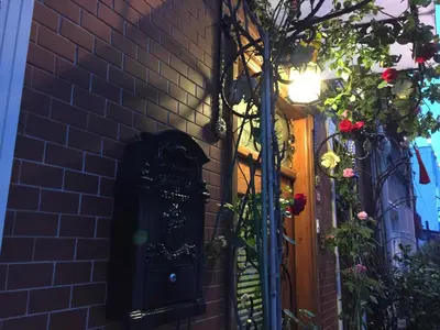 a brick wall with a door and flowers on it at Ahmet Efendi Evi in Istanbul