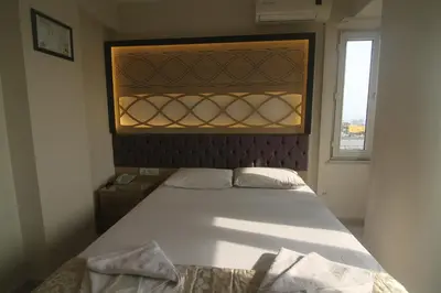 a bedroom with a large white bed with a window at Grand Liza Hotel in Istanbul