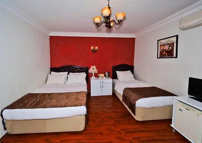 a hotel room with two beds and a television at The Sunrise Hotel in Istanbul