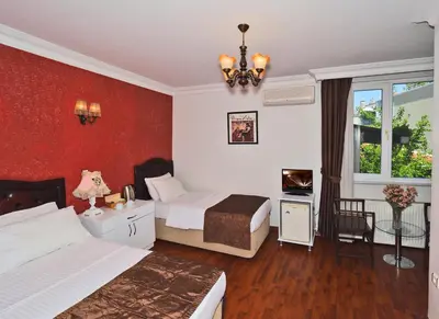 a hotel room with two beds and a window at The Sunrise Hotel in Istanbul
