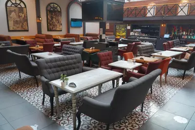 a restaurant with tables and chairs and a bar at Bern Hotel in Istanbul