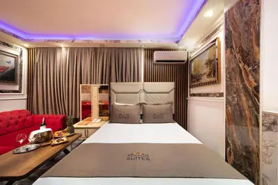 a bedroom with a bed and a red couch at REN PLUS SUITES in Istanbul