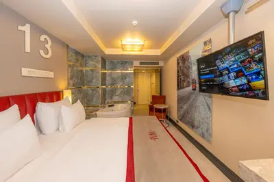 a hotel room with a large bed and a flat screen tv at Ramada By Wyndham Istanbul Pera Taksim in Istanbul