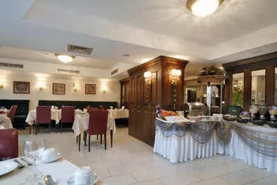 a dining room with tables and chairs in a restaurant at Hotel Daphne in Istanbul