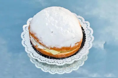a frosted donut on a plate on a table at Hotel Daphne in Istanbul