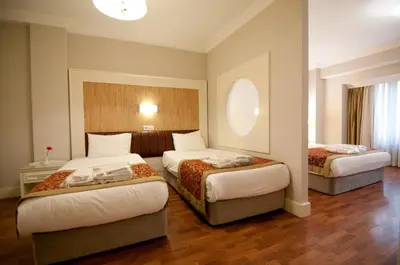 a hotel room with two beds in a room at Taksim Metropark Hotel in Istanbul