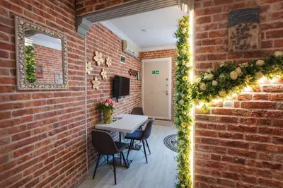 a room with a brick wall with a table and chairs at Sultanahmet Center View Apart Hotel in Istanbul