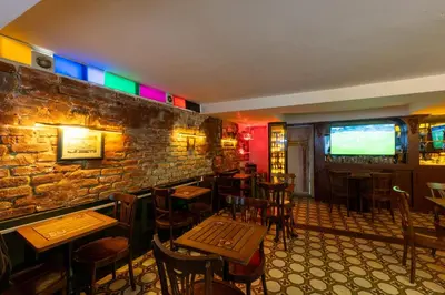 a bar with wooden tables and chairs and a television at Pera Rose Hotel & Spa - Special Category in Istanbul