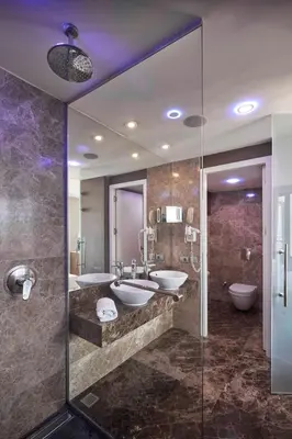 a bathroom with two sinks and two toilets at Richmond Istanbul in Istanbul