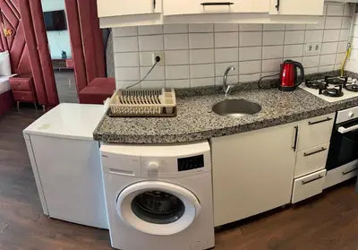 a kitchen with a washing machine and a sink at Aymira Suite Hotel in Istanbul