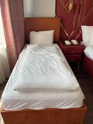 a large bed with white sheets and pillows at Aymira Suite Hotel in Istanbul