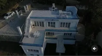 a large white house with a blue roof at WHİTE ROSE VİLLA Jakuzili ve Isıtma Havuzlu in Sapanca