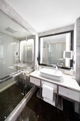 a bathroom with a sink and a mirror at The Marmara Taksim in Istanbul